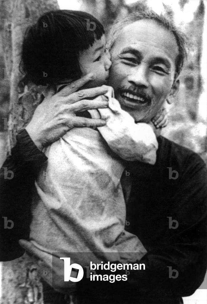 Ho Chi Minh with a child in his arms,c.1950 (photo)
