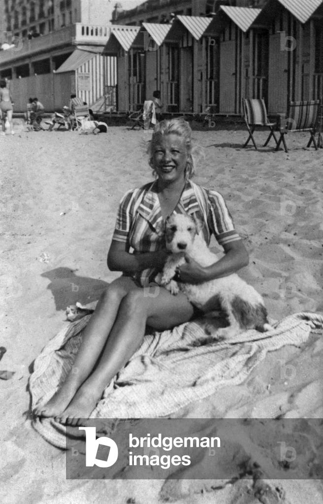 Mrs Freton with her dog on the beach in Cabourg, 1939