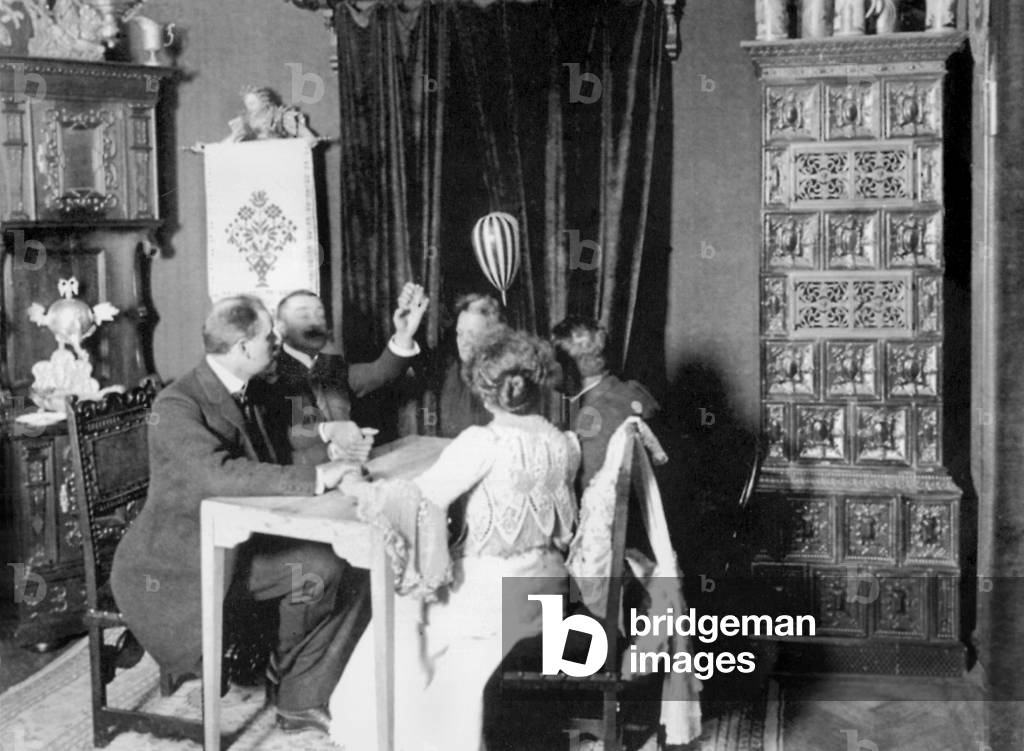Eusapia Palladino during mandolin levitation, Germany, 1903 (b/w photo)