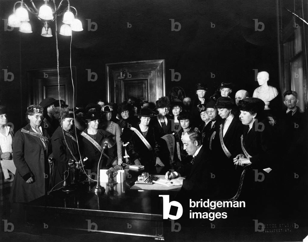 Kentucky Governor Edwin P. Morrow signs the bill ratifying the 19th Amendment on January 6, 1920, as members of the Kentucky Equal Rights Association look on, 1920 (b/w photo)