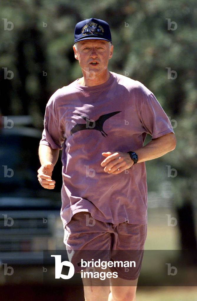 President Clinton's knee shows a deep scar as a result of his surgery as he takes a four mile jog Au.., 1997-0