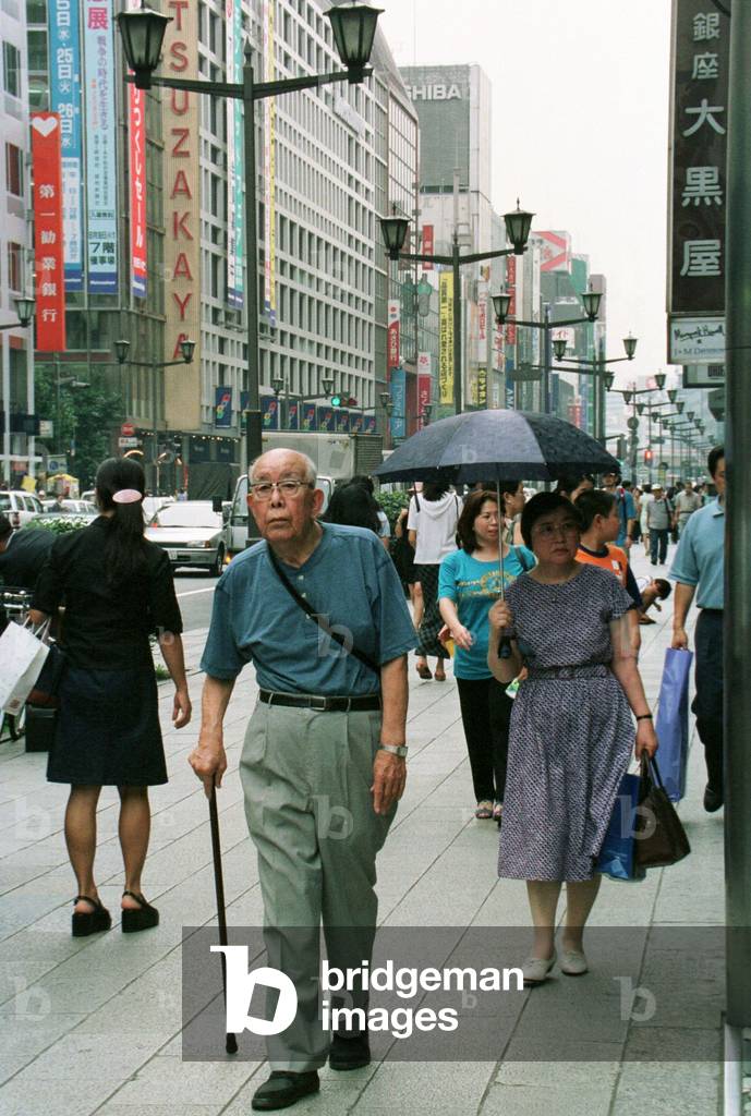 Image of PEDESTRIANS WALK ACROSS JAPAN'S MOST EXPENSIVE LAND IN TOKYO