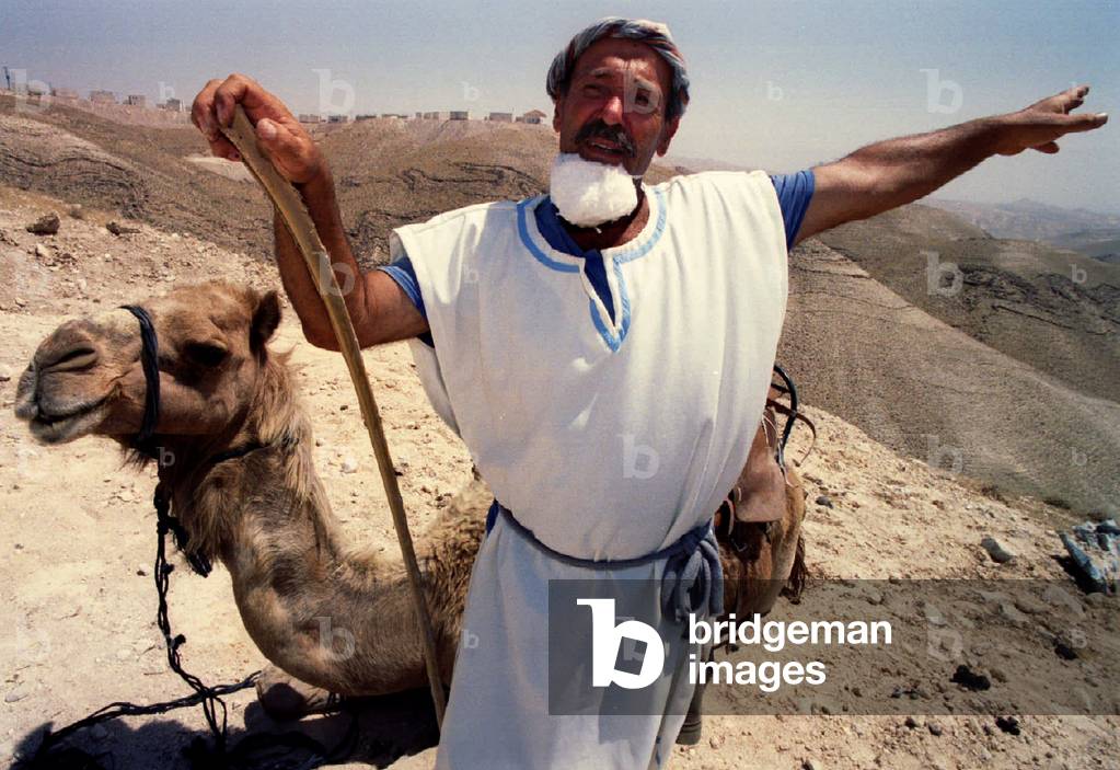 Image of A guide in ancient Hebrew dress describes biblical settlement in