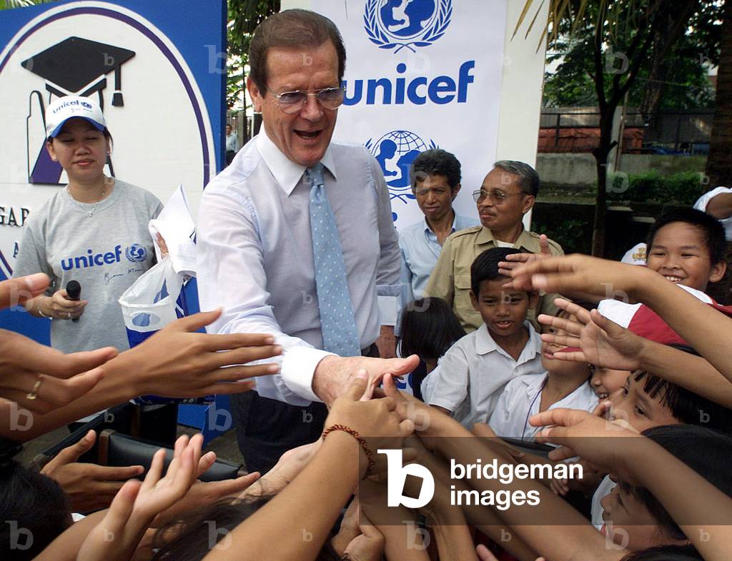 Image of British actor and UNICEF ambassador Roger Moore greets ...