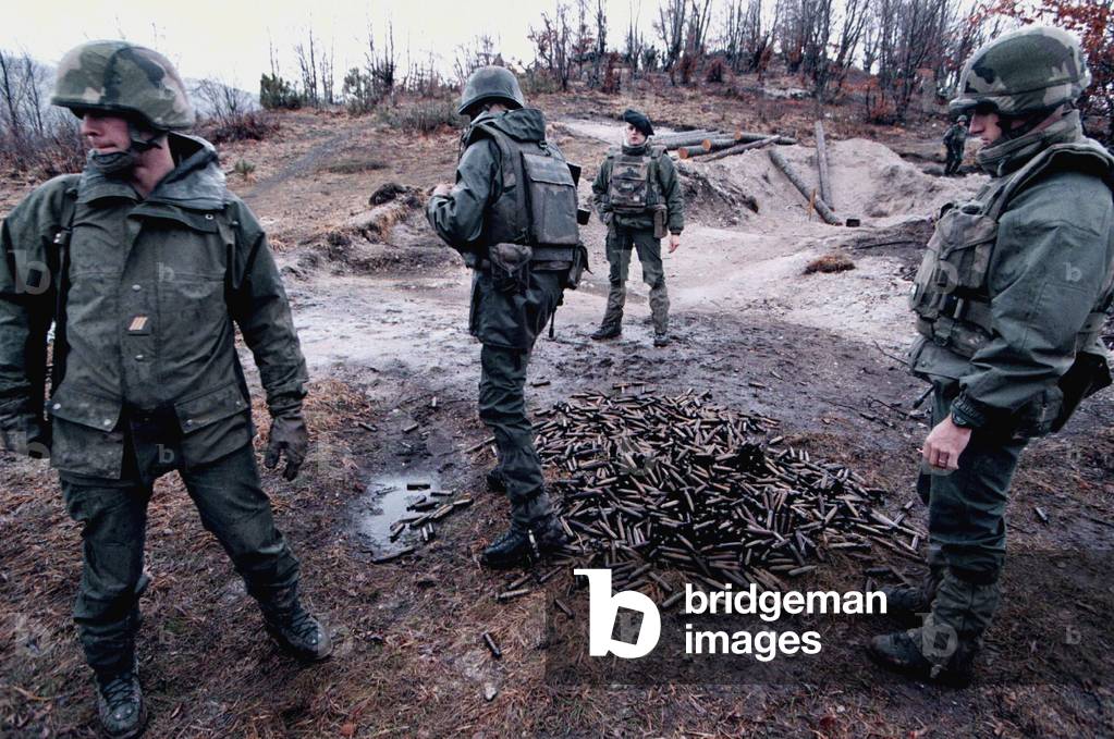 French IFOR soldiers check used amunition shells after blowing up a Bosnian bunker on Mount Igman Ja.., 1996-0