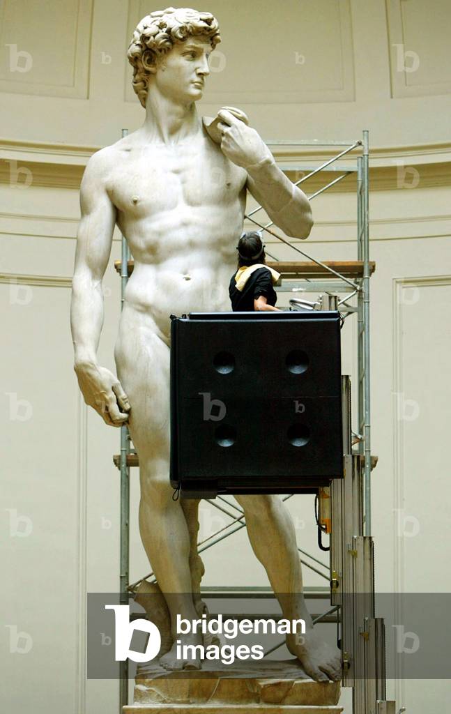 Image of Agnes Parronchi looks up as she cleans part of Michelangelo's