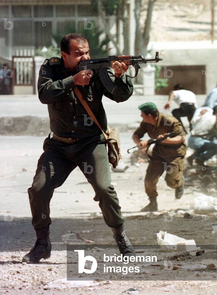 Image of A shell casing pops out as a Palestinian police officer