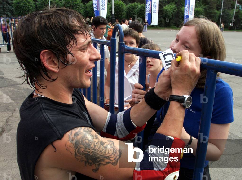 SKATEBOARDER SIGNS CARD FOR FAN DURING STREET ACTIVITIES FESTIVAL IN
ALMATY, 2003-06-21 (photo)