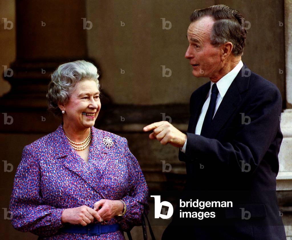Image of Former US President George Bush jokes with Queen Elizabeth II