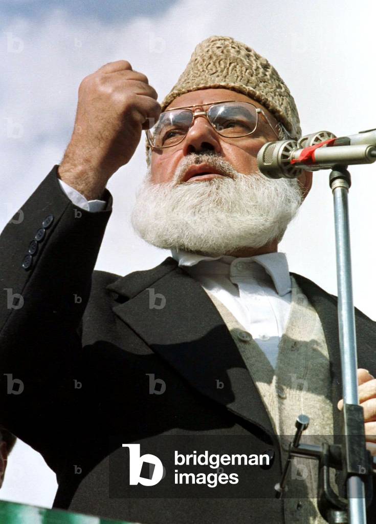 Image of Qazi Hussain Ahmad, leader of the Jamaat-i-Islami gestures as he