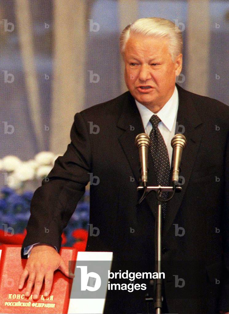 Image of Boris Yeltsin puts his hand on the constitution as he by