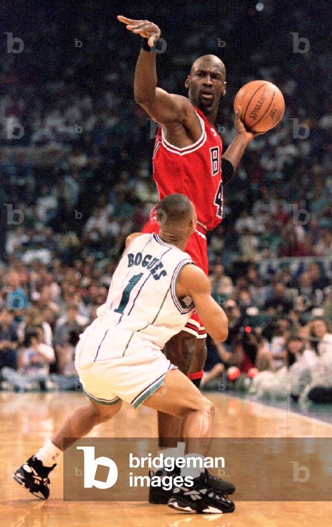 Image of Chicago Bulls' Michael Jordan keeps the ball away from