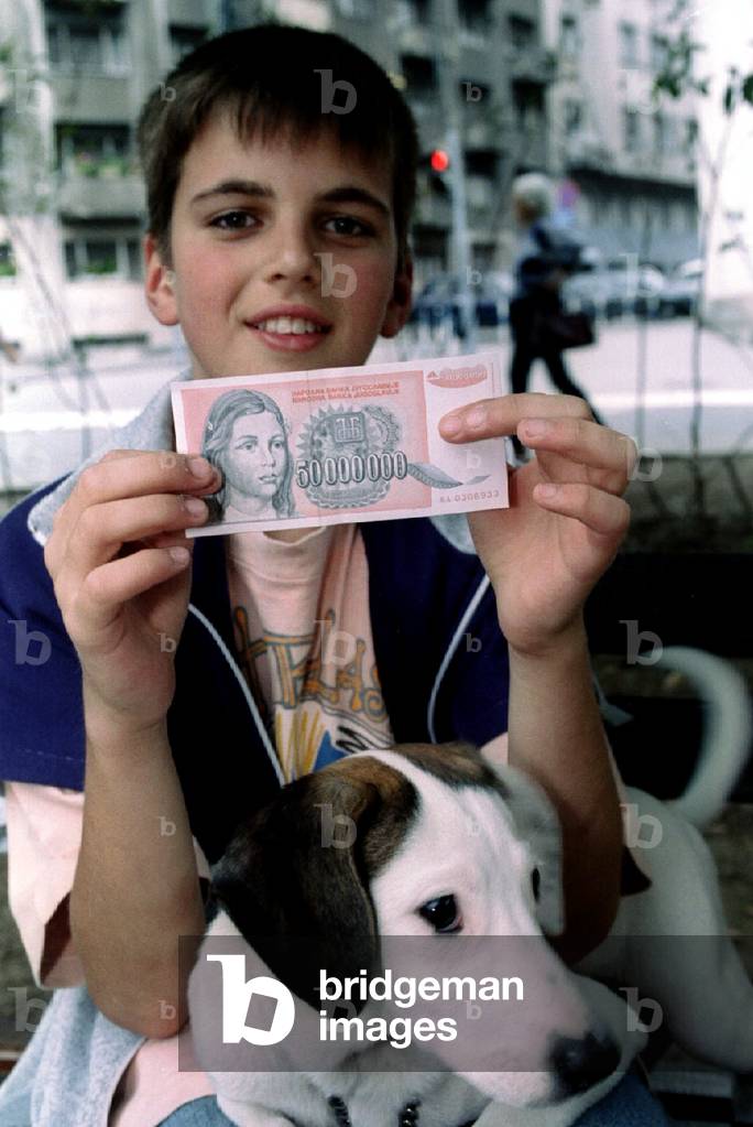 A young Belgrader showing a 50,000,000 Yugoslav dinar bank note released into circulation on July 22.., 1993-0