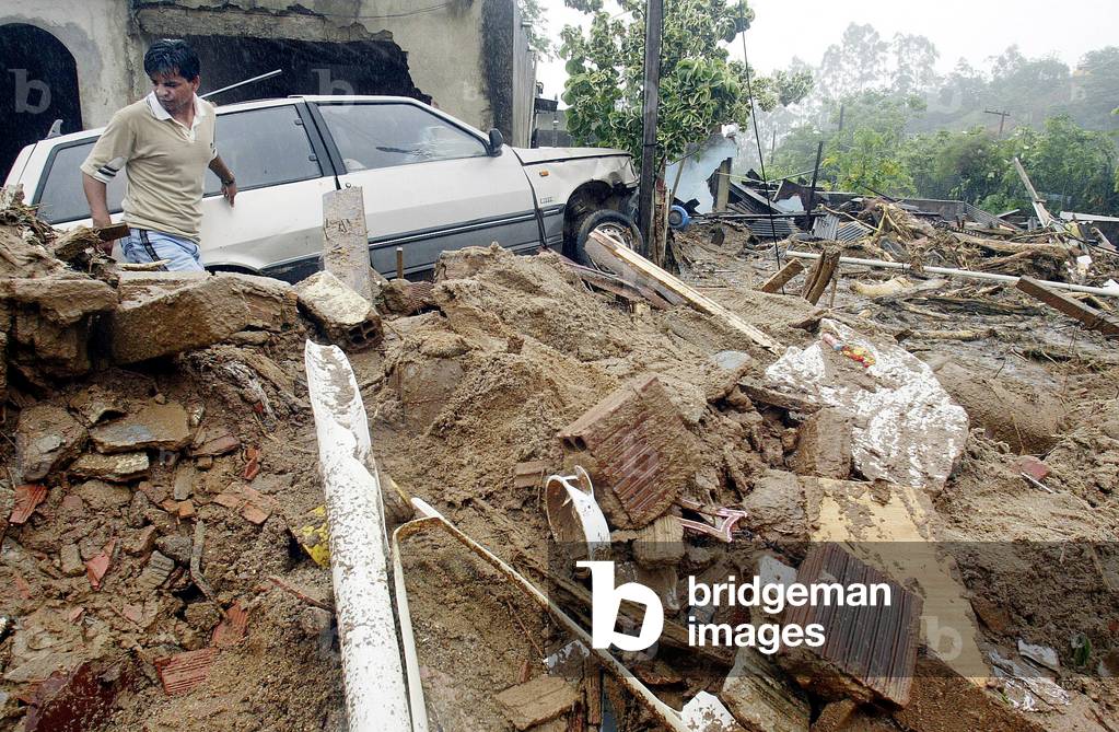 A RESIDENT WALKS NEAR HIS HOUSE AFTER MUDSLIDE IN BRAZIL, 2002-12-10 (photo)