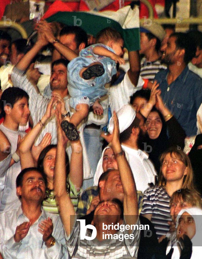 Image of SAUDI SOCCER FAN CELEBRATES GOLD MEDAL WIN, 19990920 (photo)