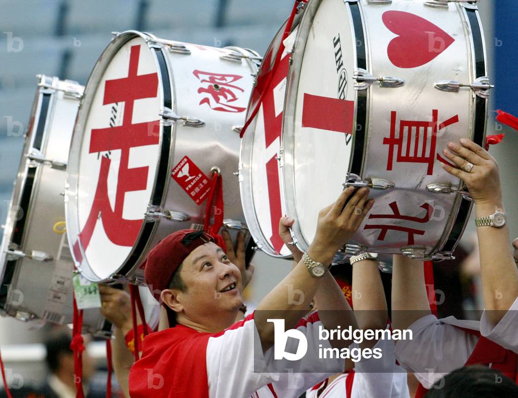 Image of CHINESE SOCCER FANS CARRY DRUMS BEFORE GROUP C MATCH BETWEEN