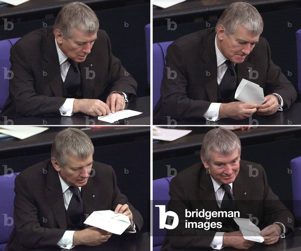 GERMAN INTERIOR MINISTER SCHILY FOLDS A PAPER PLANE DURING DEBATE AT
PARLIAMENT IN BERLIN, 2001-12-12 (photo)