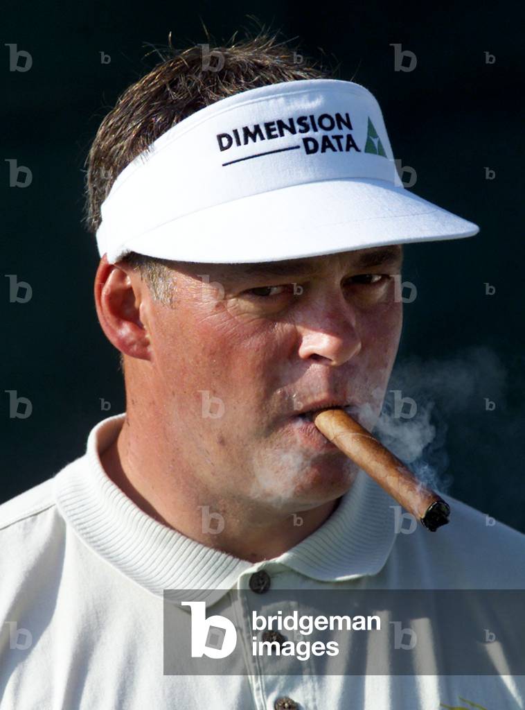 Image of GOLFER DARREN CLARKE SMOKES A CIGAR ON NINTH TEE AT
