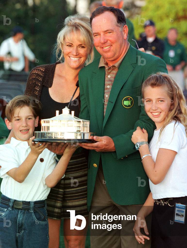 Mark O'Meara holds the Masters trophy with his wife Alicia, 8 year-old son Shaun and 11 year-old dau.., 1998-0