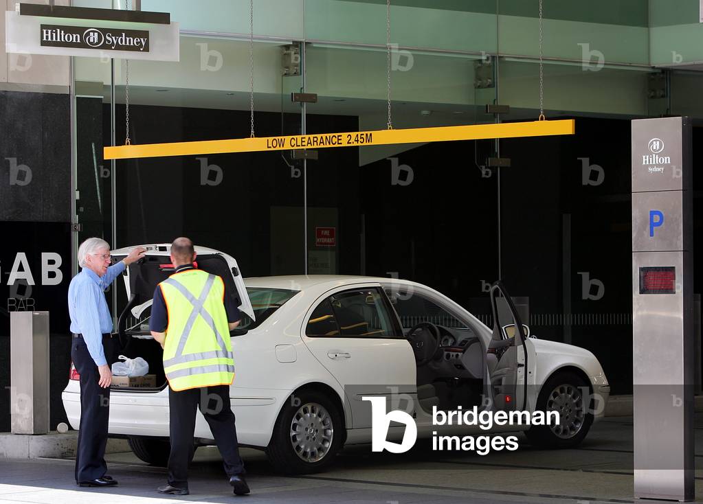 Image of A security guard inspects the interior of a car before