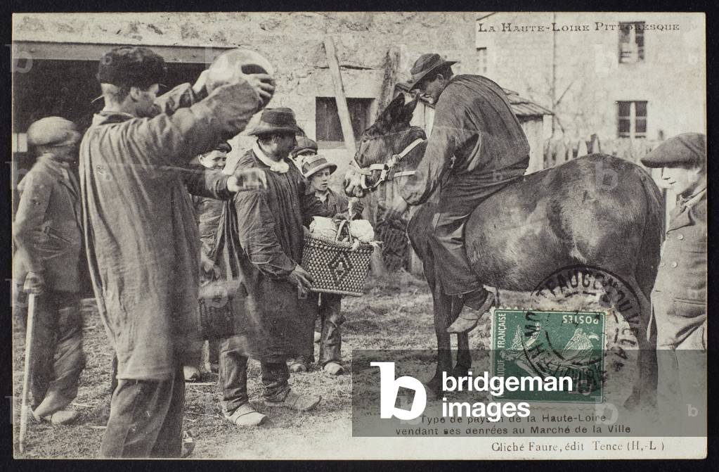 Postcard depicting a farmer in the Haute-Loire selling food at the market, c.1900 (b/w photo)