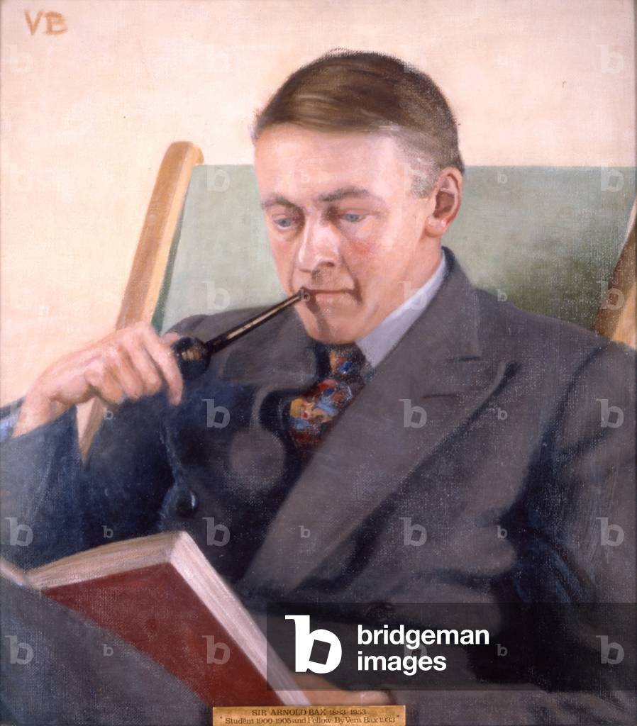 ARNOLD Bax seated with