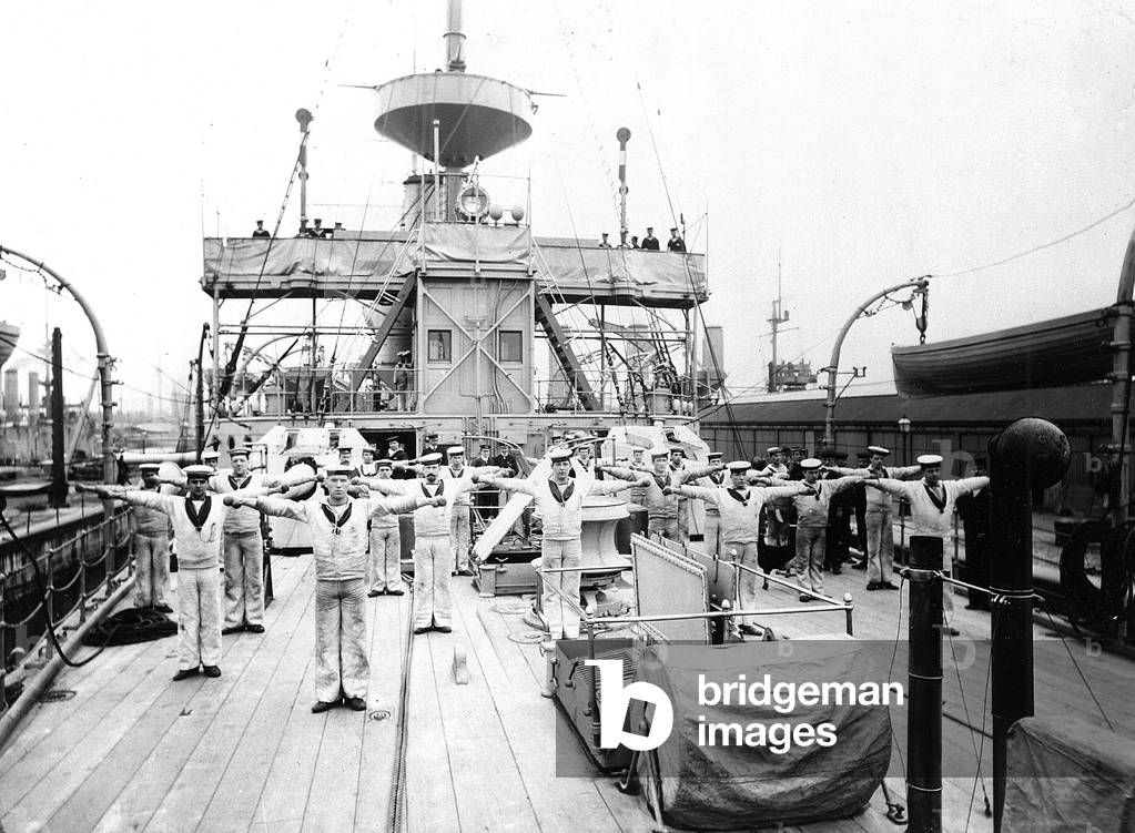 Ratings taking part in Physical Training exercises on the upper deck of an unidentified ship, c.1900 (b/w photo)