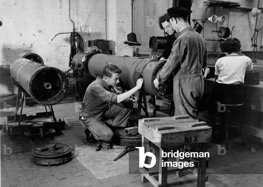 Royal Navy and Womens Royal Navy Service (WRNS) personnel in a mine workshop at the shore establishment HMS Vernon, Portsmouth, c.1941 (b/w photo)