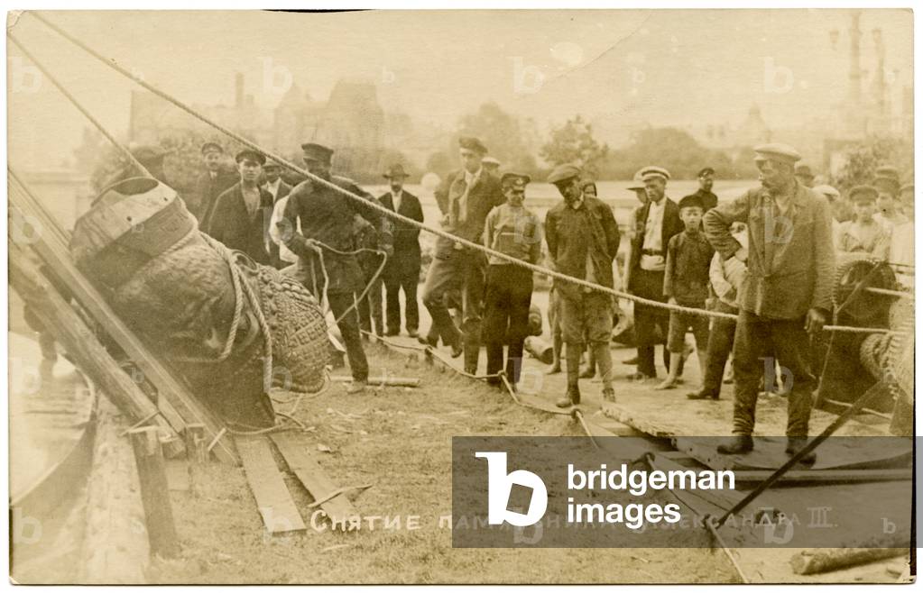 Russian photographic postcard depicting the removal of the statue of Tsar Alexander III in Petrograd (Saint Petersburg) by the Bolshevik Regime, 1918