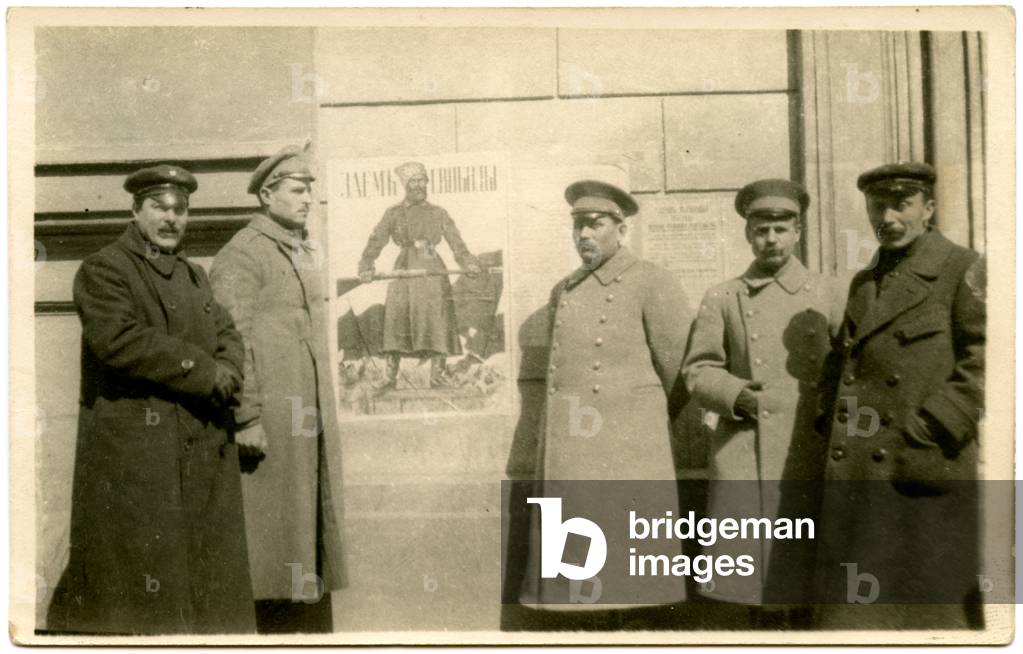 Postcard Depicting Russian Soldiers Standing in front of a Wall Pasted with Revolutionary Placards, 1917