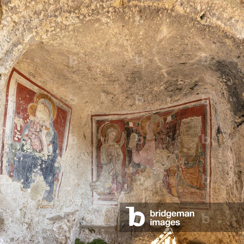 frescoes in the Rock Church of Our Lady of the Three Doors. On the right the “Deesis” and on the left a Madonna del Pomegranano, both by the Master of Miglionico, 15th century Matera, Basilicata, Italy.