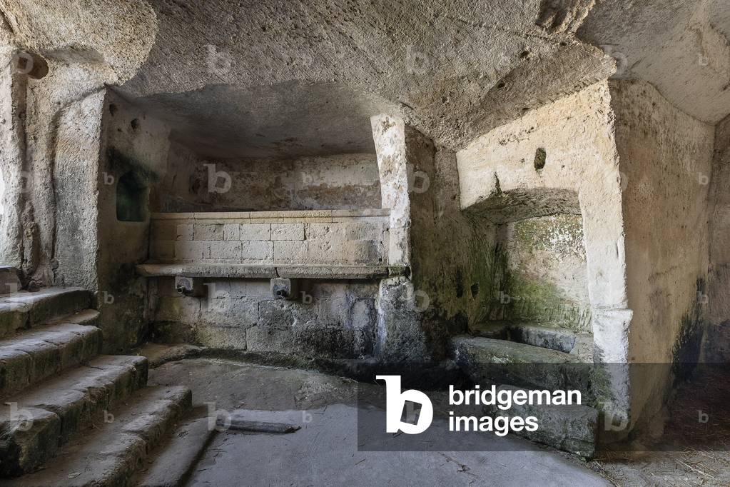 Millstone in a cave house in the rocks of Matera, Italy (photo)