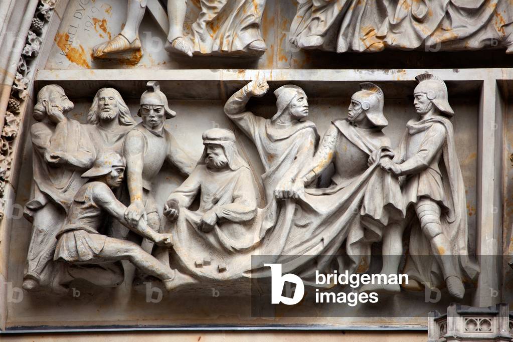 Tympanum reliefs above the central portal in the western facade, depicting a game of dice for Christ's garments after his crucifixion, carved c.1949, St. Vitus Cathedral, Prague (photo)
