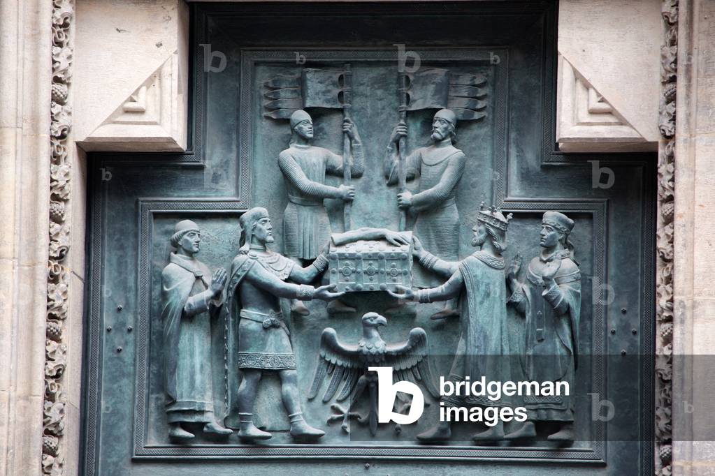 Upper left panel of the bronze door of the central portal in the western facade, depicting St. Wenceslas receiving the remains of St. Vitus from Emperor Henry, cast c.1926-29, St. Vitus Cathedral, Prague (photo)