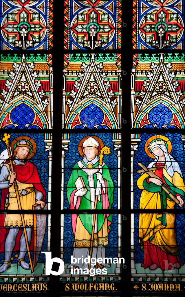 Stained glass window depicting (from left to right) St. Wenceslaus, St Wolfgang, and St Joanna (photo)