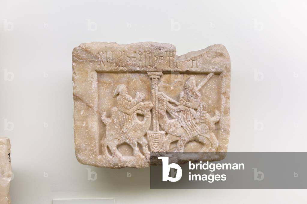 Yemenite relief of a woman and a man, seated on dromedaries, meeting at a well