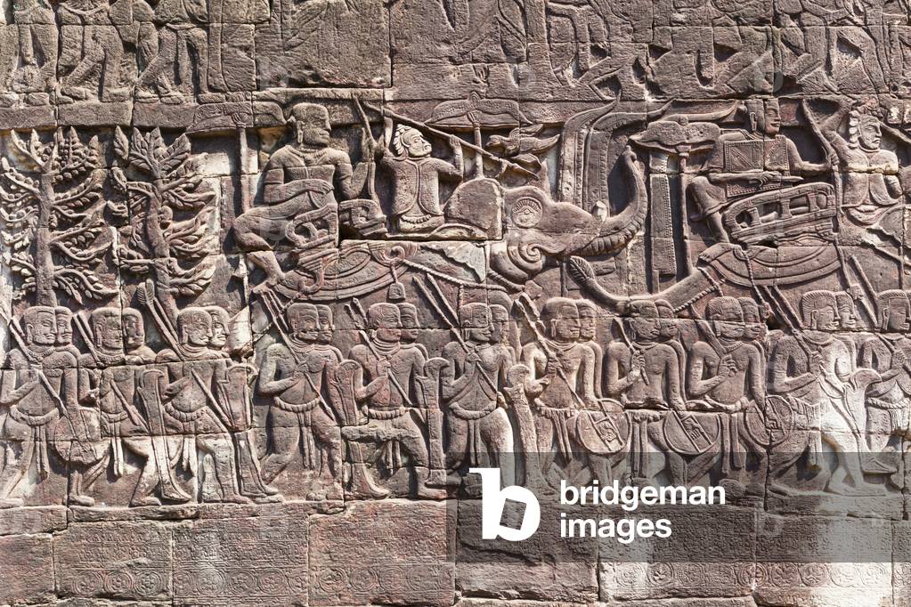 Bas reliefs on the west side of the Bayon Temple depicting Khmer soldiers marching, Angkor archaeological site, Cambodia (photo)
