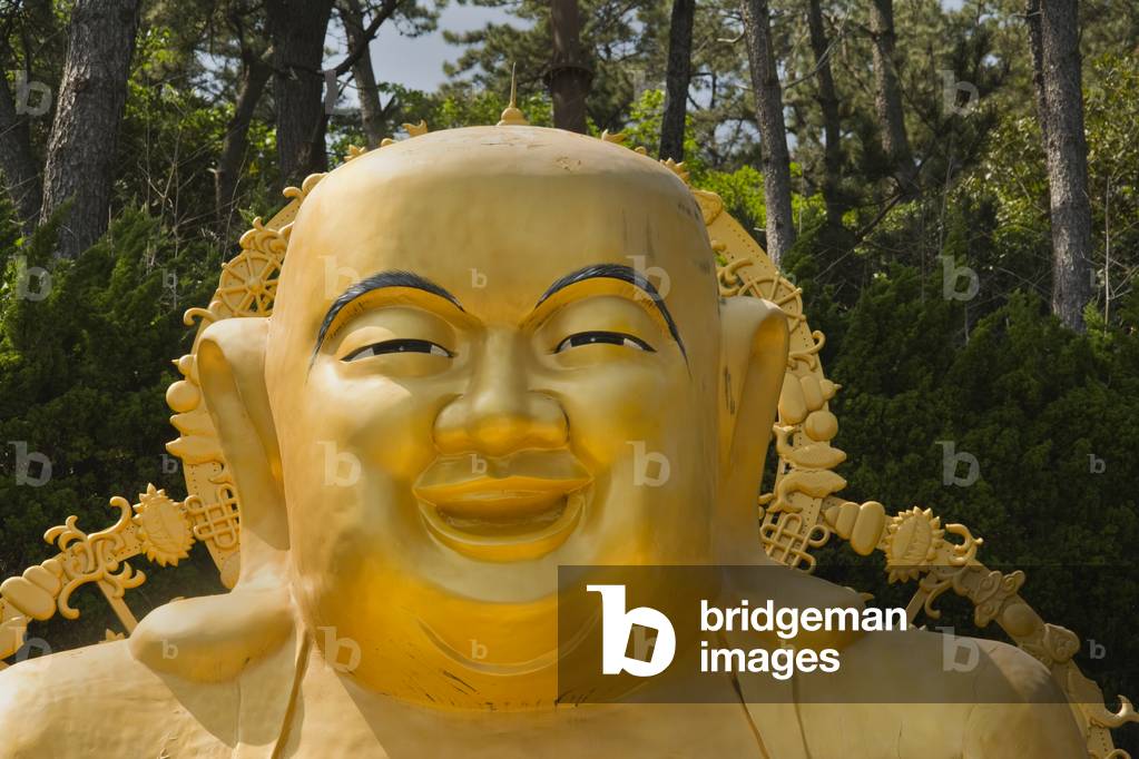 Golden seated Buddha statue,  Haedong Yonggung  Buddhist Temple (1376), Gijang-gun,  Busan, South Korea (photo)