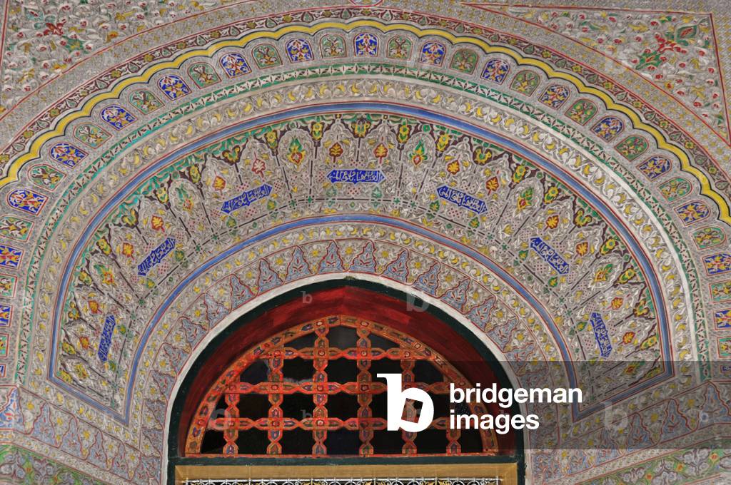 Fes. Interior of Mnebhi Palace, early 20th cent. Islamic architecture. Decorated arch. Colourful mosaic. Floral patterns. Morocco