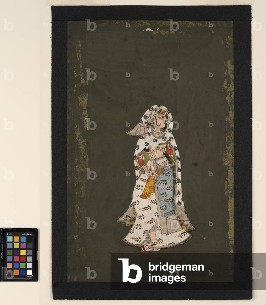 A standing woman in floral patterned white sari, a peacock-plume patterned cloak, 18th century (opaque w/c on paper)