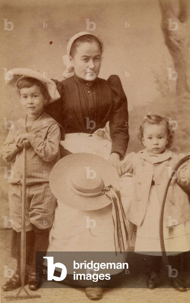 Children with their nanny, 1895 (sepia photo)