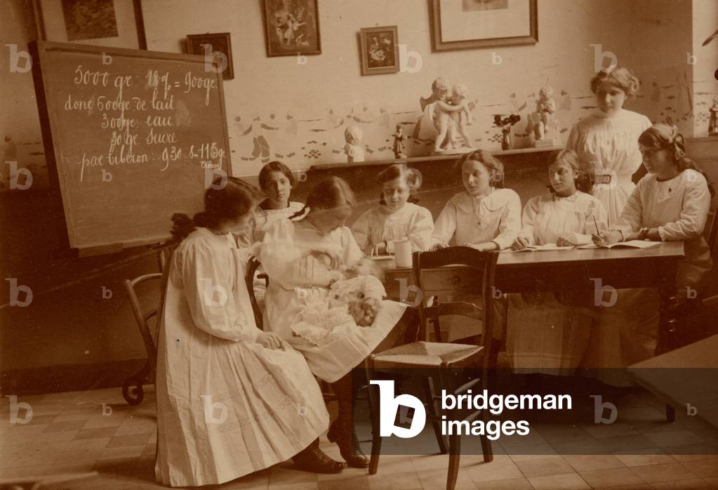 Childcare class with a real baby and bottle, c.1890 (sepia photo)