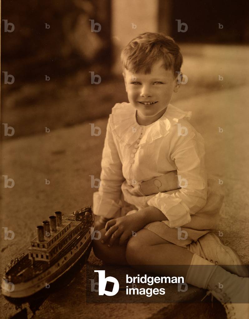 Boy playing with a Marklin 'Viktoria' model boat, 1919 (sepia photo)