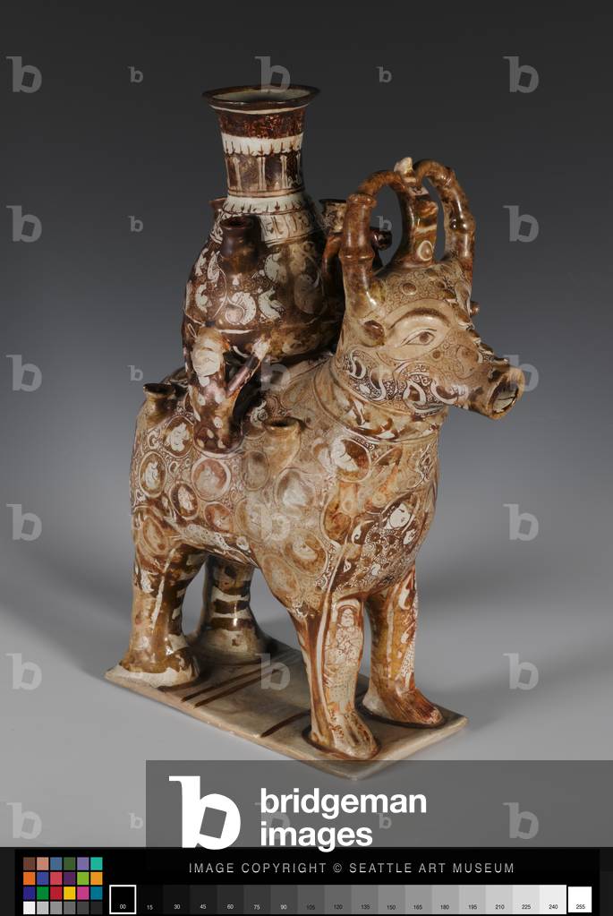 Container in the form of a bull bearing a pot,
12th to early 13th century (Stonepaste; glazed in opaque white, luster
painted (with later repairs))