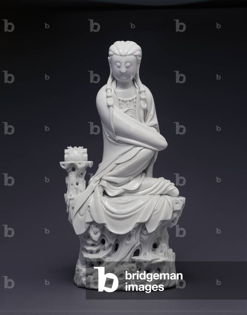 Figure of Guanyin, 18th - 19th century (Dehua porcelain (porcelain modeled with a
female figure sitting on a tall, reticulated
taihu rock))