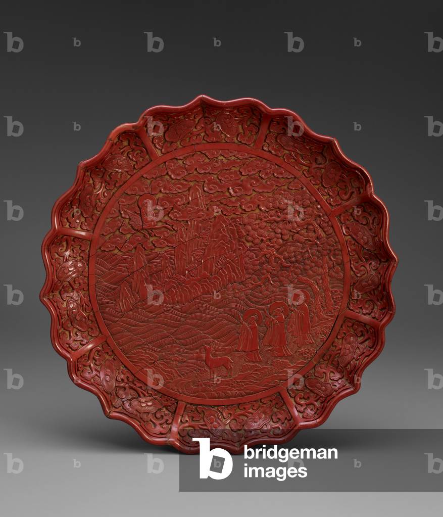 Dish with foliated rim, illustrating Shou Lao
flying in landscape, beginning of 15th
century (Carved red lacquer on wood)