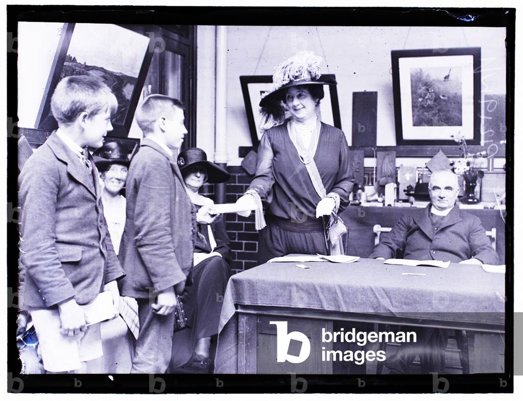 Mrs Stanley Baldwin presenting prizes to schoolchildren, 24th July 1923 (b/w photo)