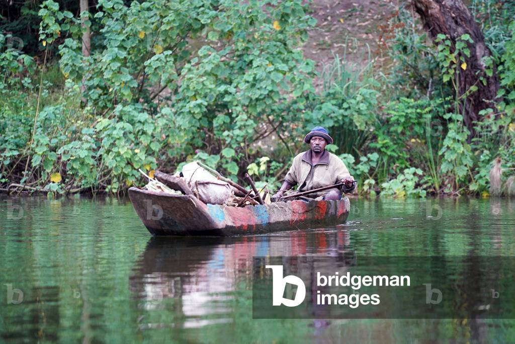 Fisherman in a dugout canoe, Uganda