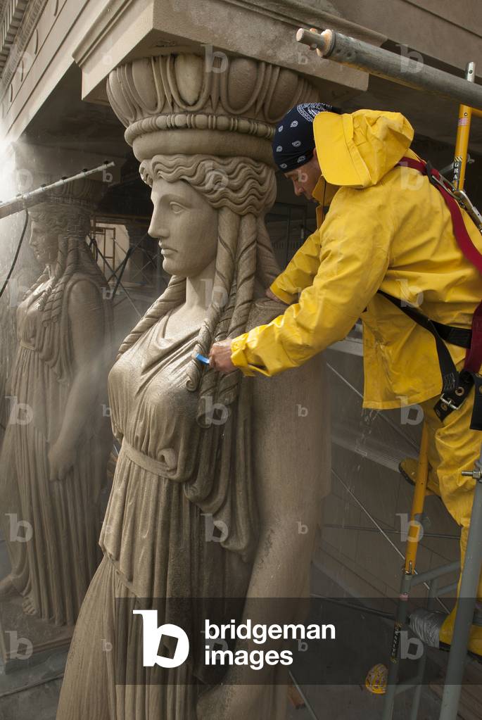 A Museum Employee Cleaning One Of The Caryatid On The Façade Of The Museum Of Science And Industry