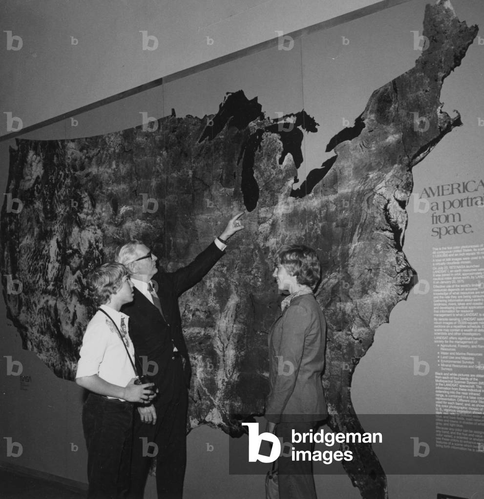 A Gentleman Points To The Location Of Chicago On A Portrait Of America As Viewed From Space